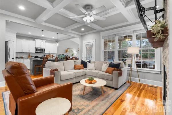 a kitchen with granite countertop a stove and a wooden floor