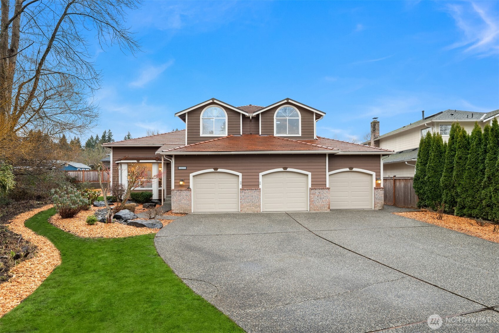 a front view of a house with a yard and garage