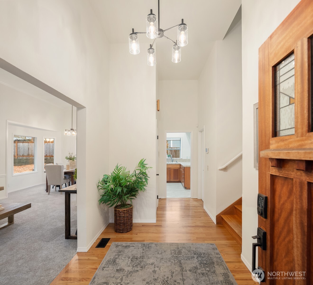 1425 243rd Place Southwest Bothell, WA 98021 - Photo 3 of 39 a hallway with wooden floor and a potted plant