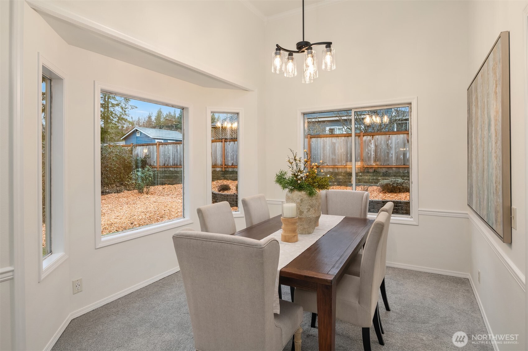 1425 243rd Place Southwest Bothell, WA 98021 - Photo 7 of 39 a dining room with furniture a chandelier and wooden floor