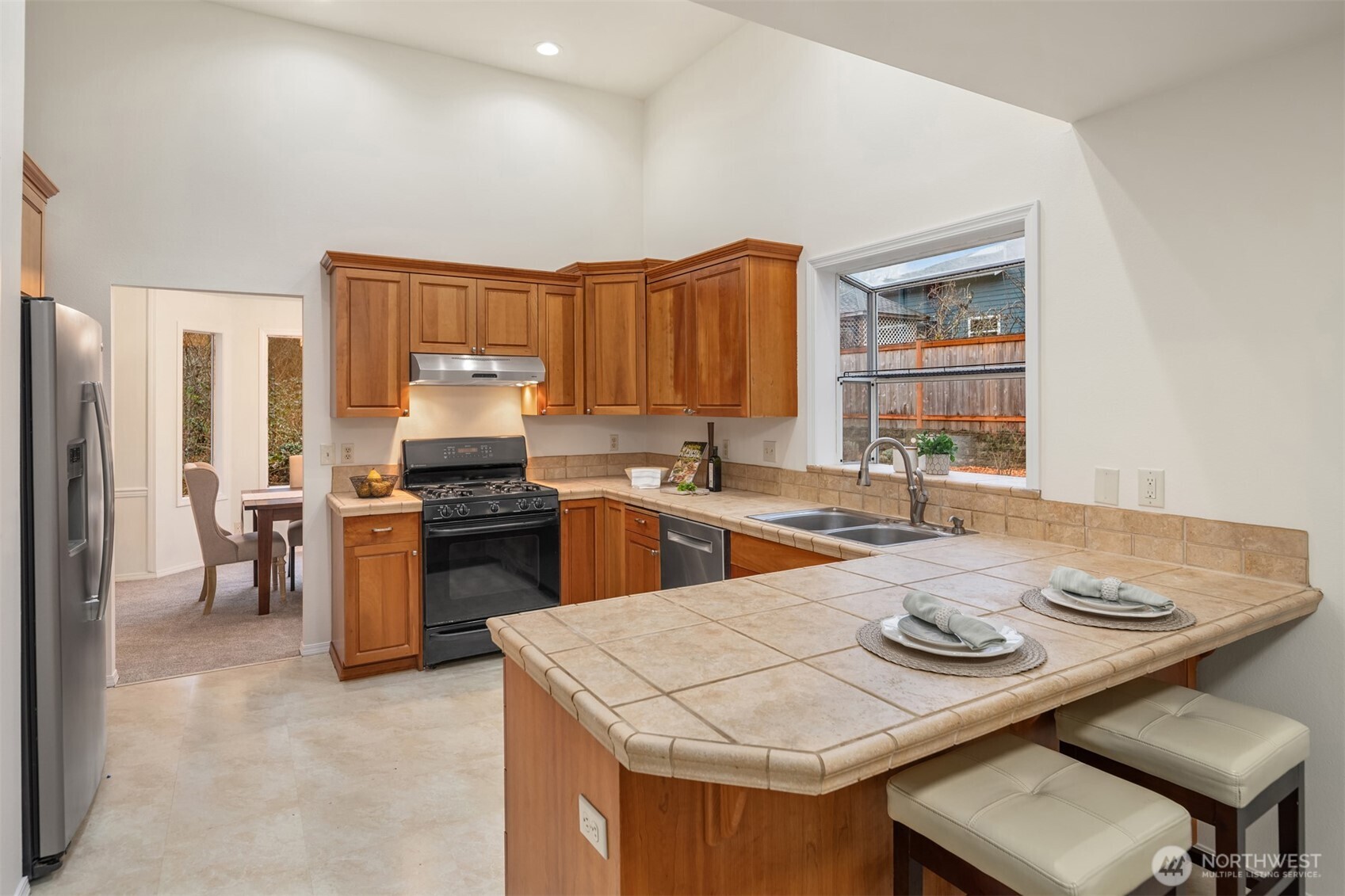 1425 243rd Place Southwest Bothell, WA 98021 - Photo 8 of 39 a kitchen with a sink a stove and chairs