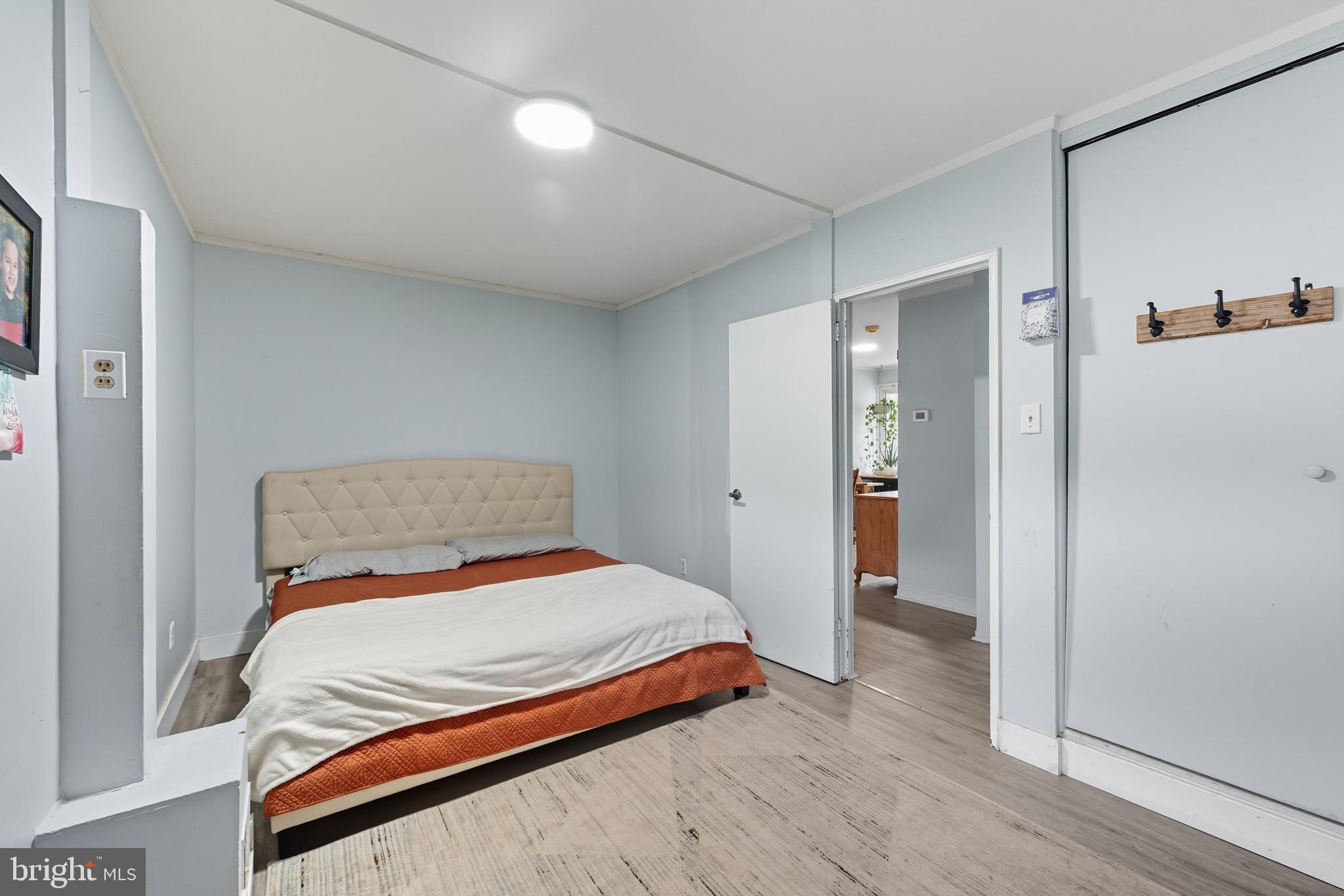 7626 Greenleaf Road Landover, MD 20785 - Photo 12 of 24 a bedroom with a bed and wooden floor