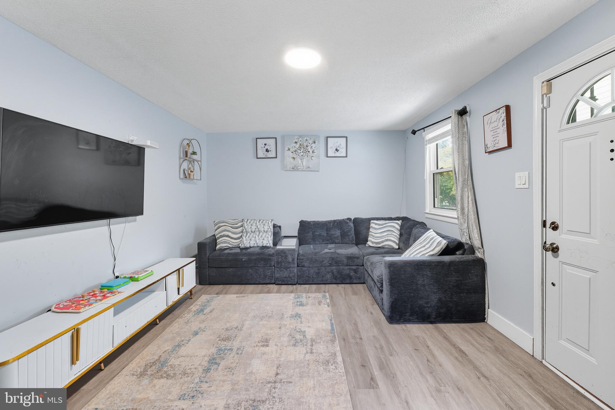 7626 Greenleaf Road Landover, MD 20785 - Photo 3 of 24 a living room with furniture and a flat screen tv