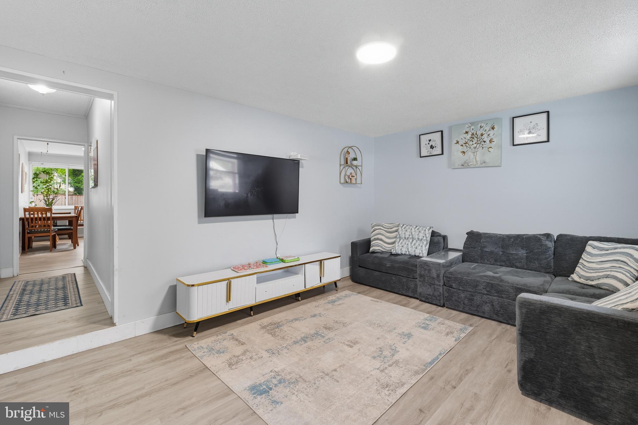 7626 Greenleaf Road Landover, MD 20785 - Photo 4 of 24 a living room with furniture and a flat screen tv