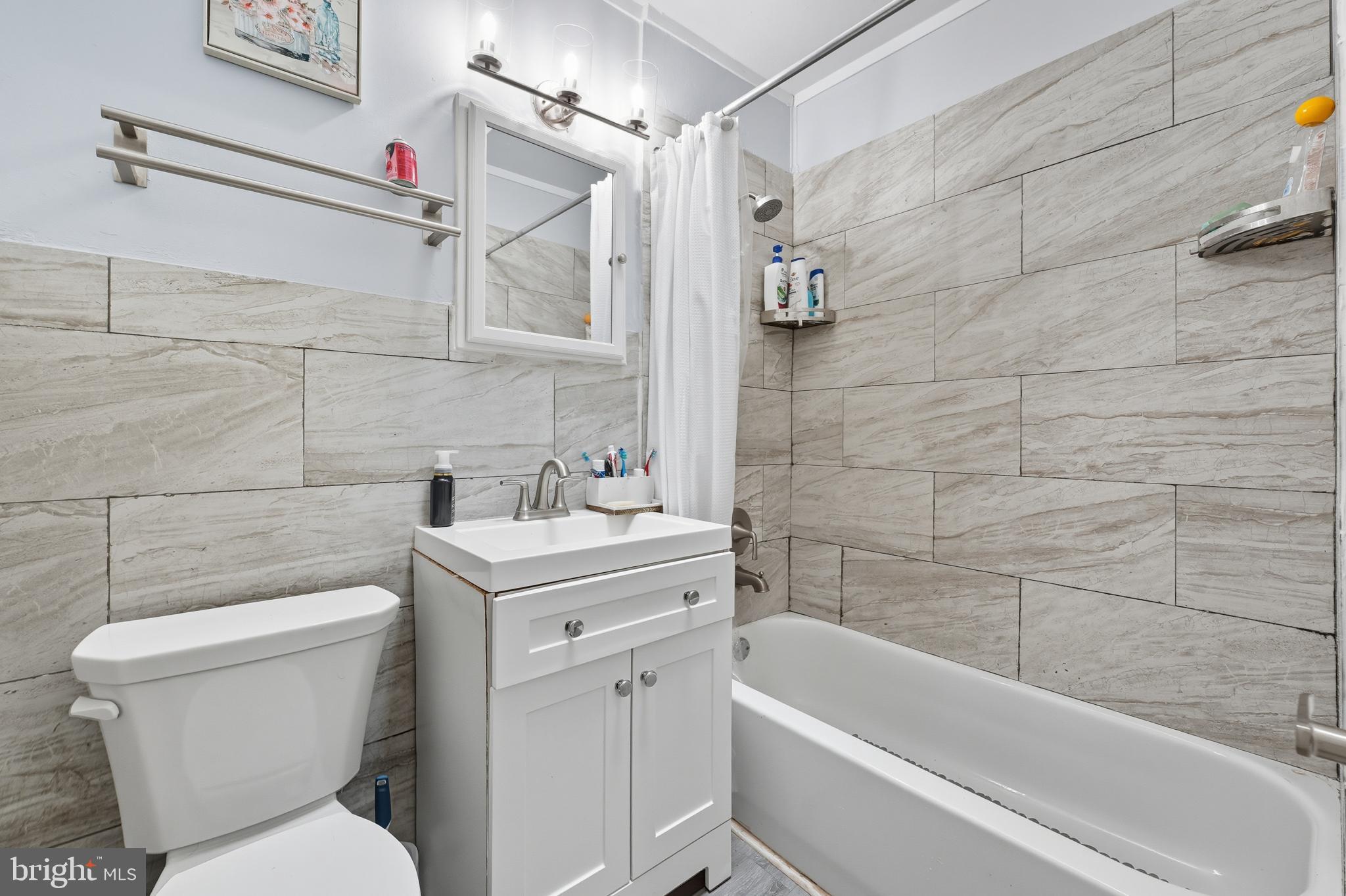 7626 Greenleaf Road Landover, MD 20785 - Photo 6 of 24 a bathroom with a toilet sink and bathtub