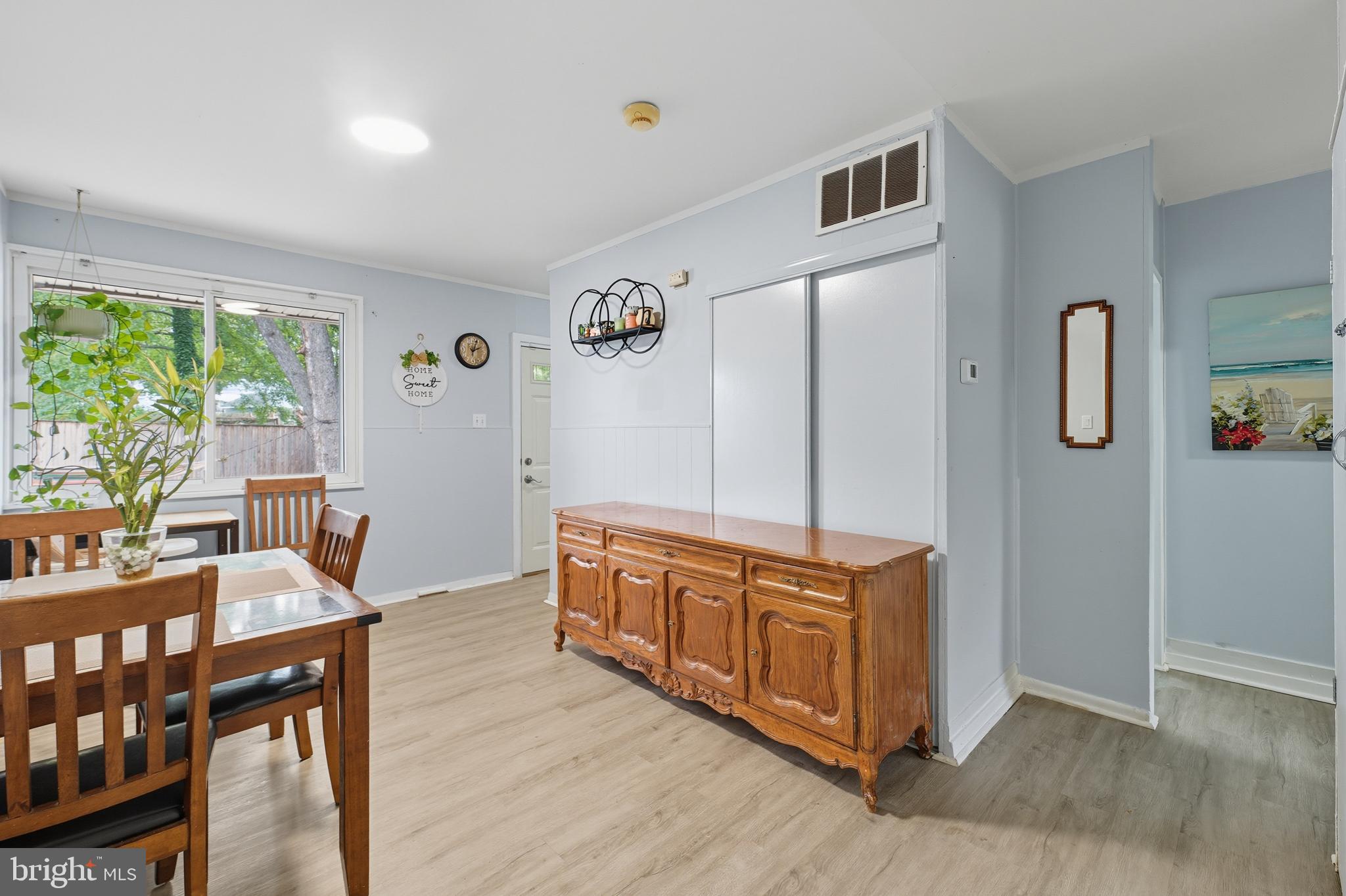 7626 Greenleaf Road Landover, MD 20785 - Photo 9 of 24 a room with stainless steel appliances kitchen island granite countertop a table chairs in it and wooden floors
