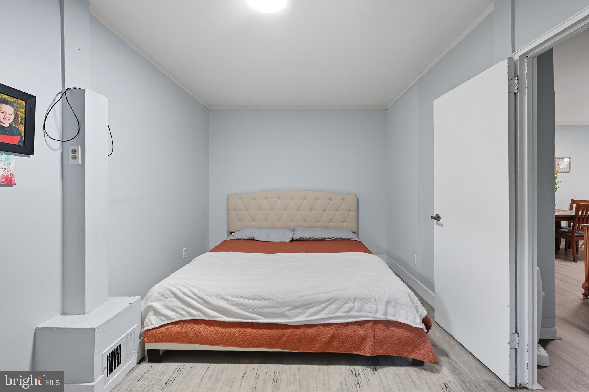 7626 Greenleaf Road Landover, MD 20785 - Photo 10 of 24 a bed sitting in a bedroom next to a window