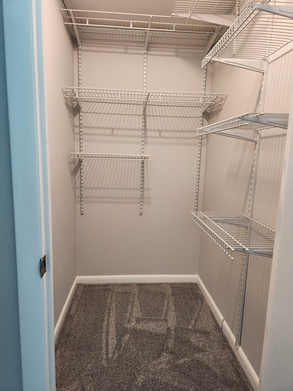 29 Sherman Street, Unit 1 Foxboro, MA 02035 - Photo 12 of 16 a view of a room with racks on the wall