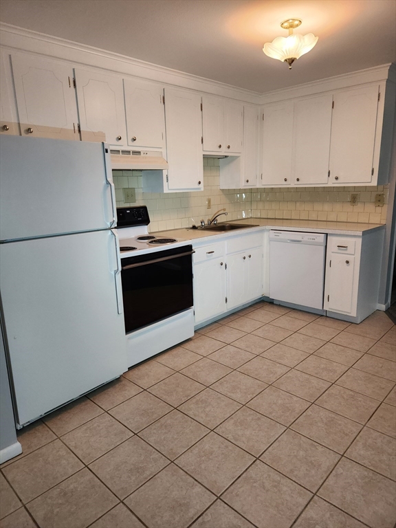 29 Sherman Street, Unit 1 Foxboro, MA 02035 - Photo 3 of 16 a kitchen with granite countertop white cabinets and white appliances