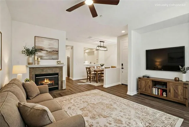an empty room with wooden floor fireplace and window