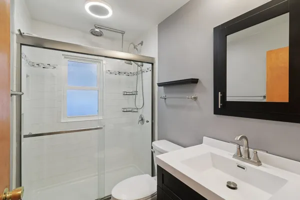 a bathroom with a sink toilet and shower