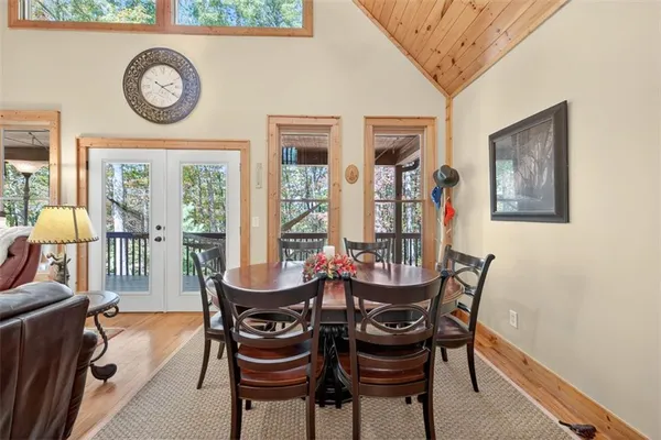 a dining room with furniture and a large window