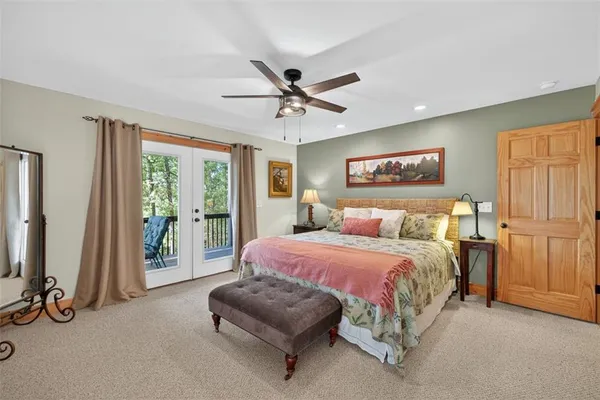 a spacious bedroom with a bed and a chandelier