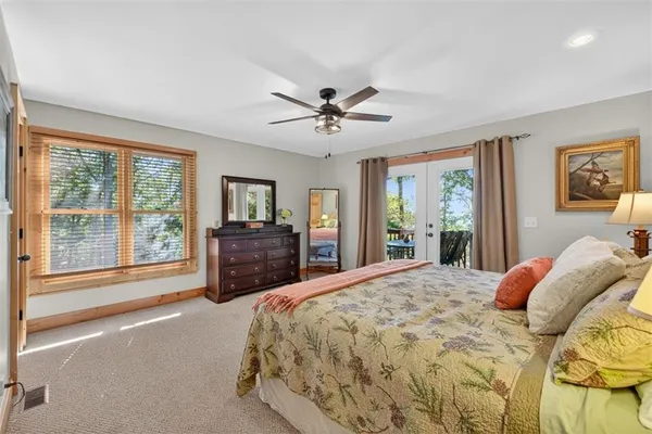 a bedroom with a large bed and a large window