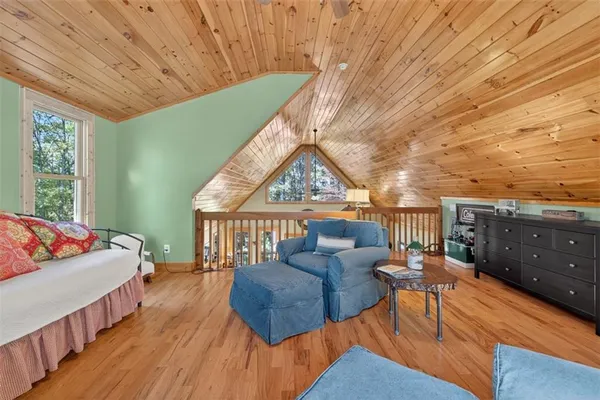a balcony with furniture and a wooden floor