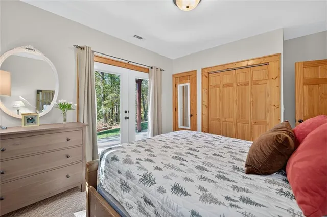 a bedroom with two beds and a flat screen tv