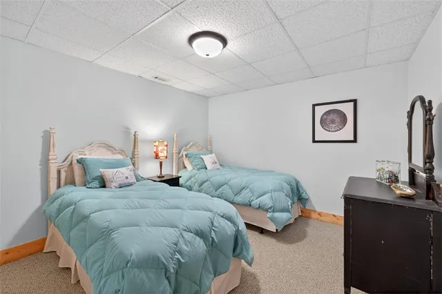 a bathroom with a granite countertop toilet and a sink