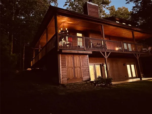 a view of a house with a yard and tree s