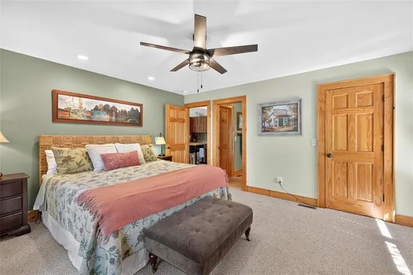 a bedroom with a large bed and a chandelier