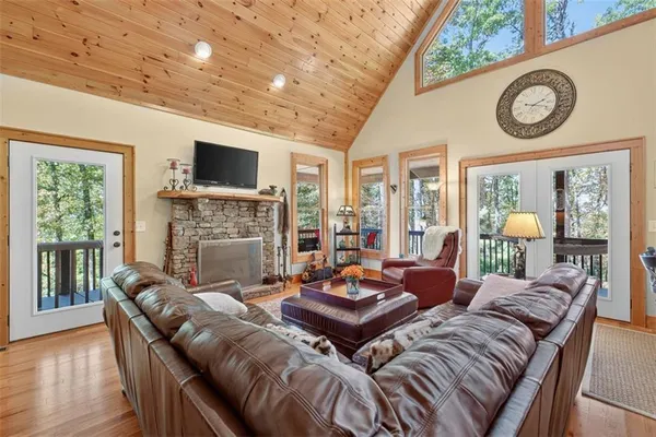 a living room with furniture a fireplace and a flat screen tv