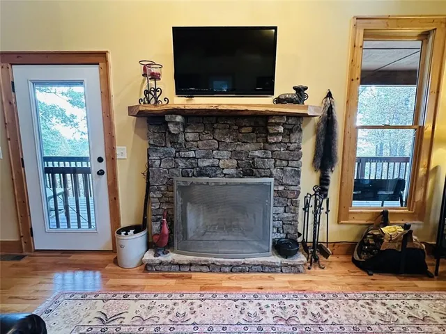 a living room with fireplace and a flat screen tv