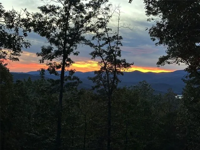 a balcony with wooden floor table and chairs