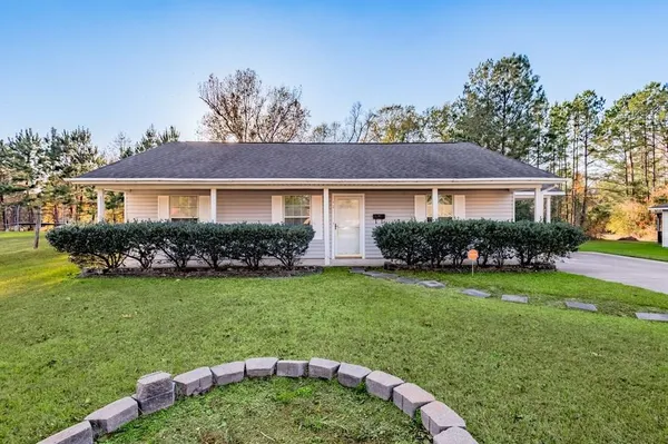 a front view of a house with a garden