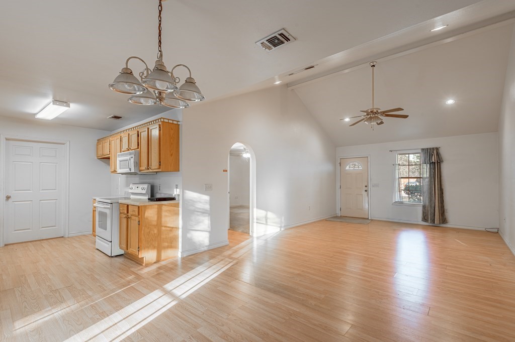 111 Hemlock Road Lufkin, TX 75901 - Photo 13 of 41 a view of a room with a chandelier and wooden floor