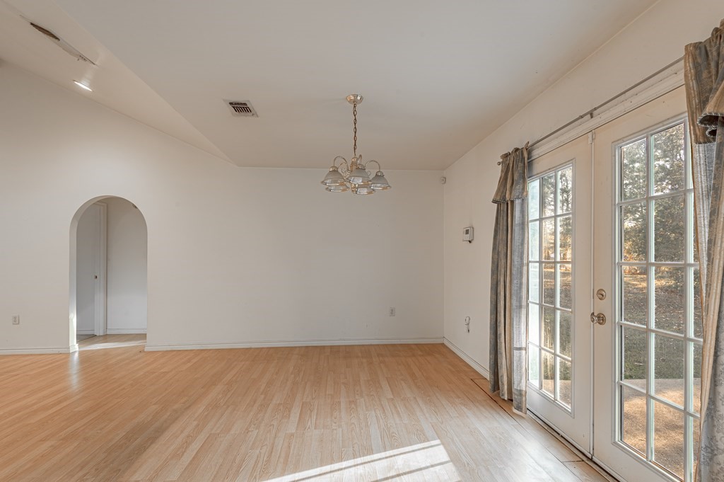 111 Hemlock Road Lufkin, TX 75901 - Photo 14 of 41 wooden floor in an empty room with a window