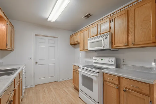 a kitchen with stainless steel appliances granite countertop a sink stove and cabinets