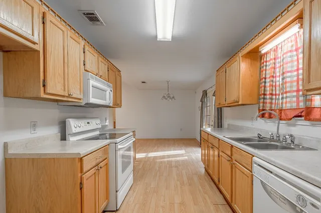 a kitchen with stainless steel appliances granite countertop a stove and a refrigerator