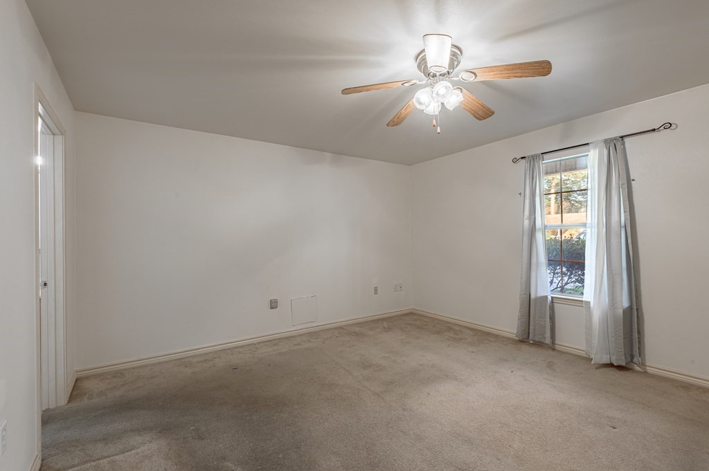 111 Hemlock Road Lufkin, TX 75901 - Photo 19 of 41 an empty room with windows and fan