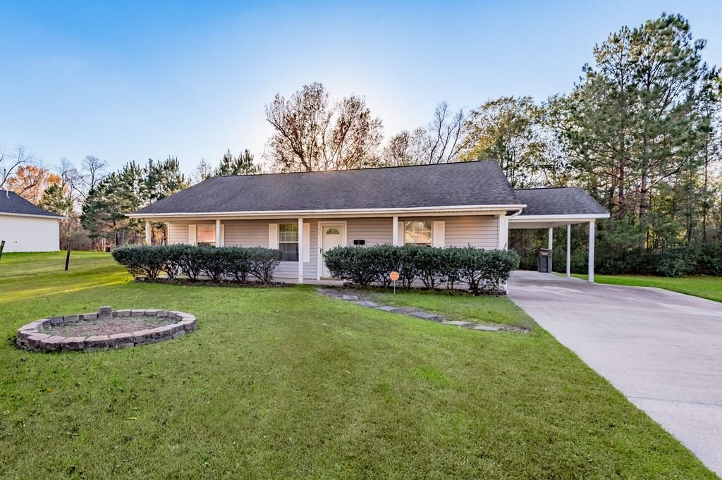 111 Hemlock Road Lufkin, TX 75901 - Photo 2 of 41 a front view of a house with a garden