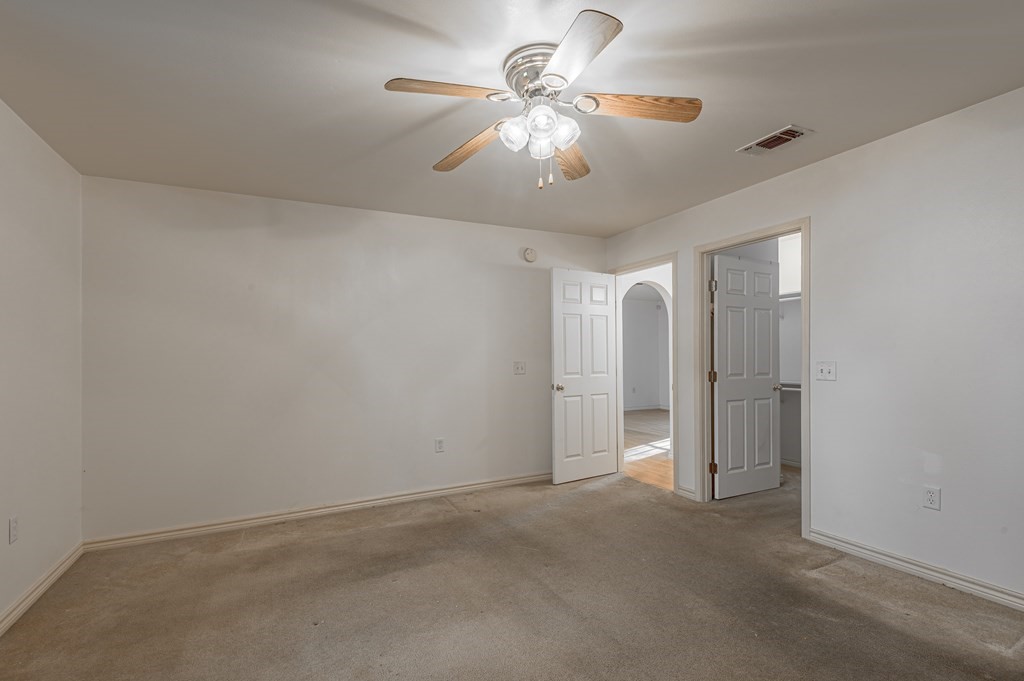111 Hemlock Road Lufkin, TX 75901 - Photo 21 of 41 an empty room with chandelier fan and windows