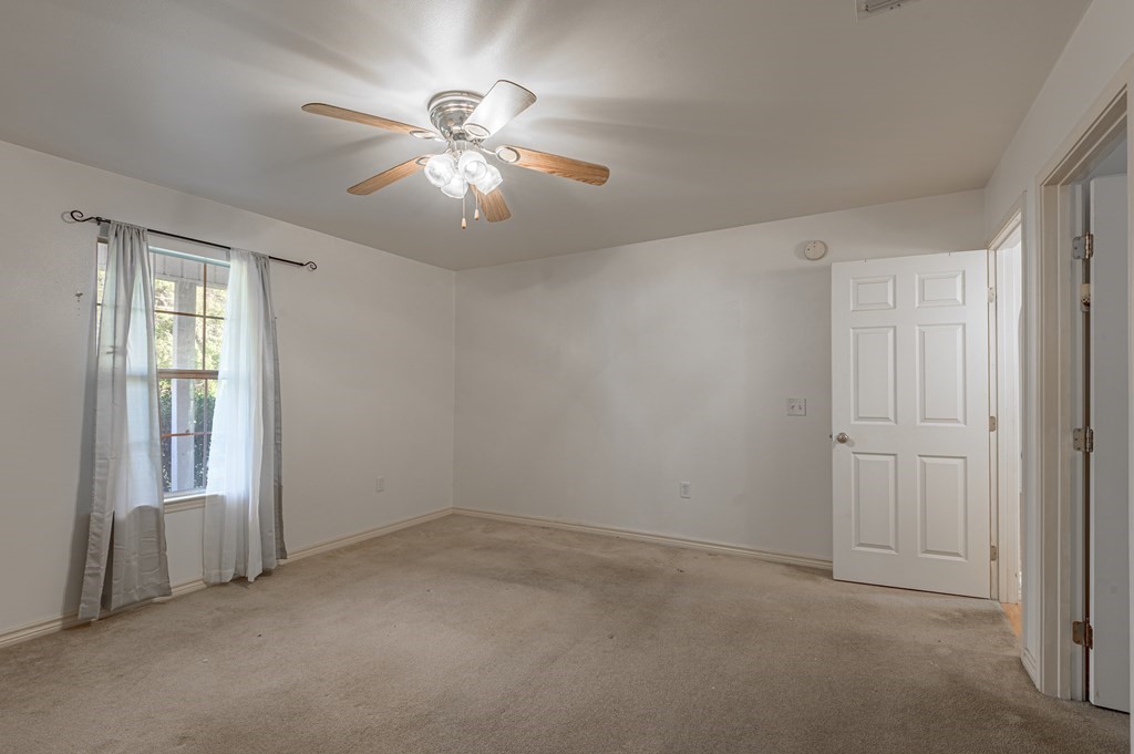 111 Hemlock Road Lufkin, TX 75901 - Photo 22 of 41 an empty room with windows and fan