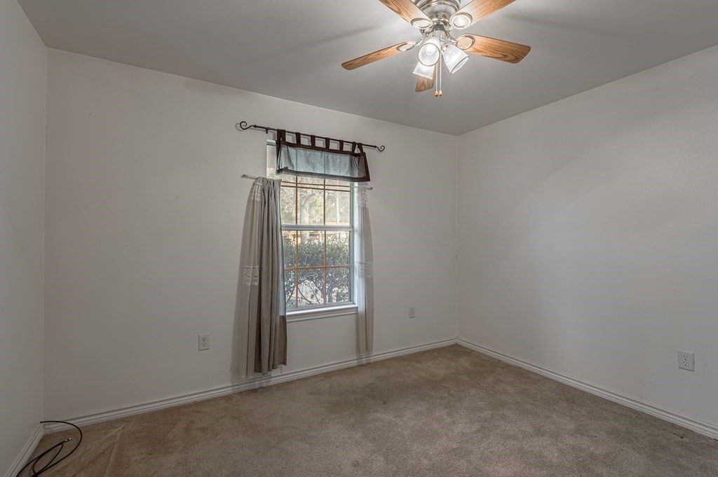 111 Hemlock Road Lufkin, TX 75901 - Photo 25 of 41 an empty room with windows and chandelier fan