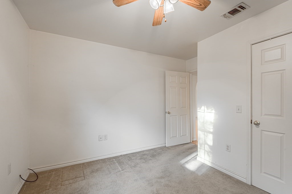 111 Hemlock Road Lufkin, TX 75901 - Photo 30 of 41 an empty room with a chandelier fan