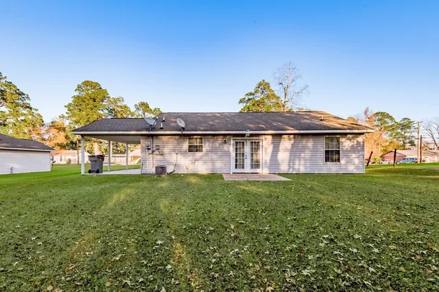 a view of a house with a backyard