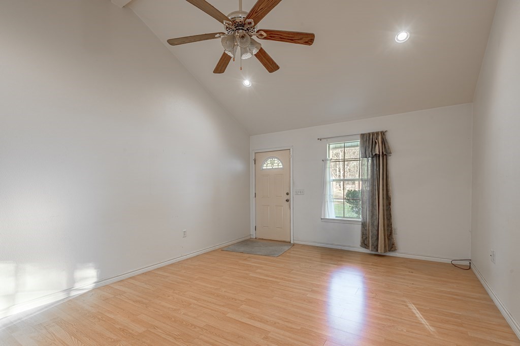 111 Hemlock Road Lufkin, TX 75901 - Photo 9 of 41 an empty room with wooden floor fan and windows