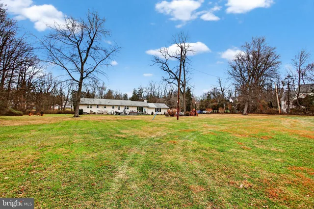 a front view of a house with swimming pool having outdoor seating