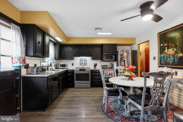 a view of a dining room with furniture and wooden floor