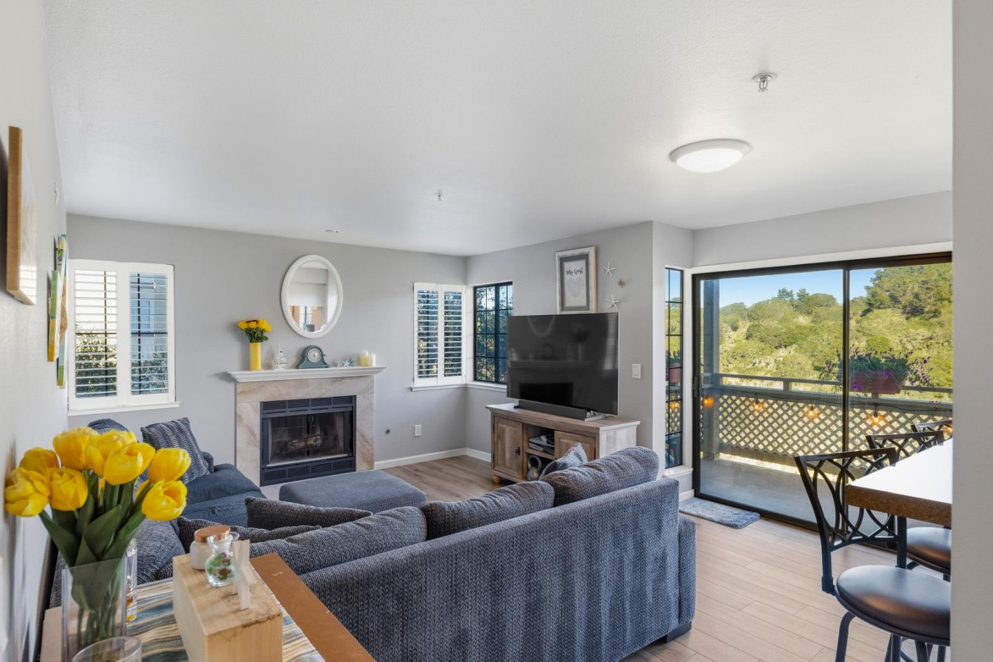 a living room with furniture a fireplace and a flat screen tv