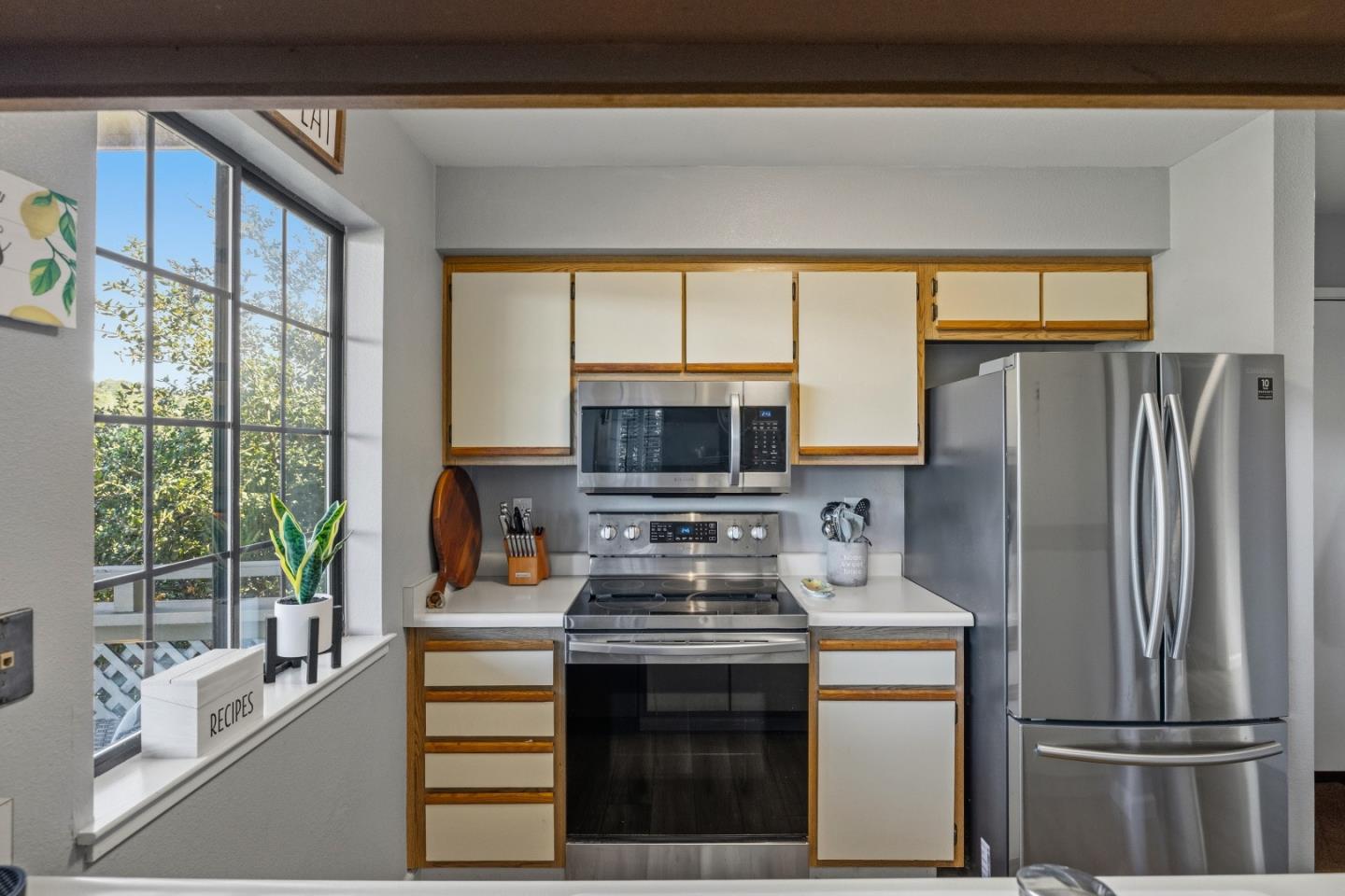 521 Quail Run Court Del Rey Oaks, CA 93940 - Photo 13 of 31 a kitchen with a stove a refrigerator and a view of living room