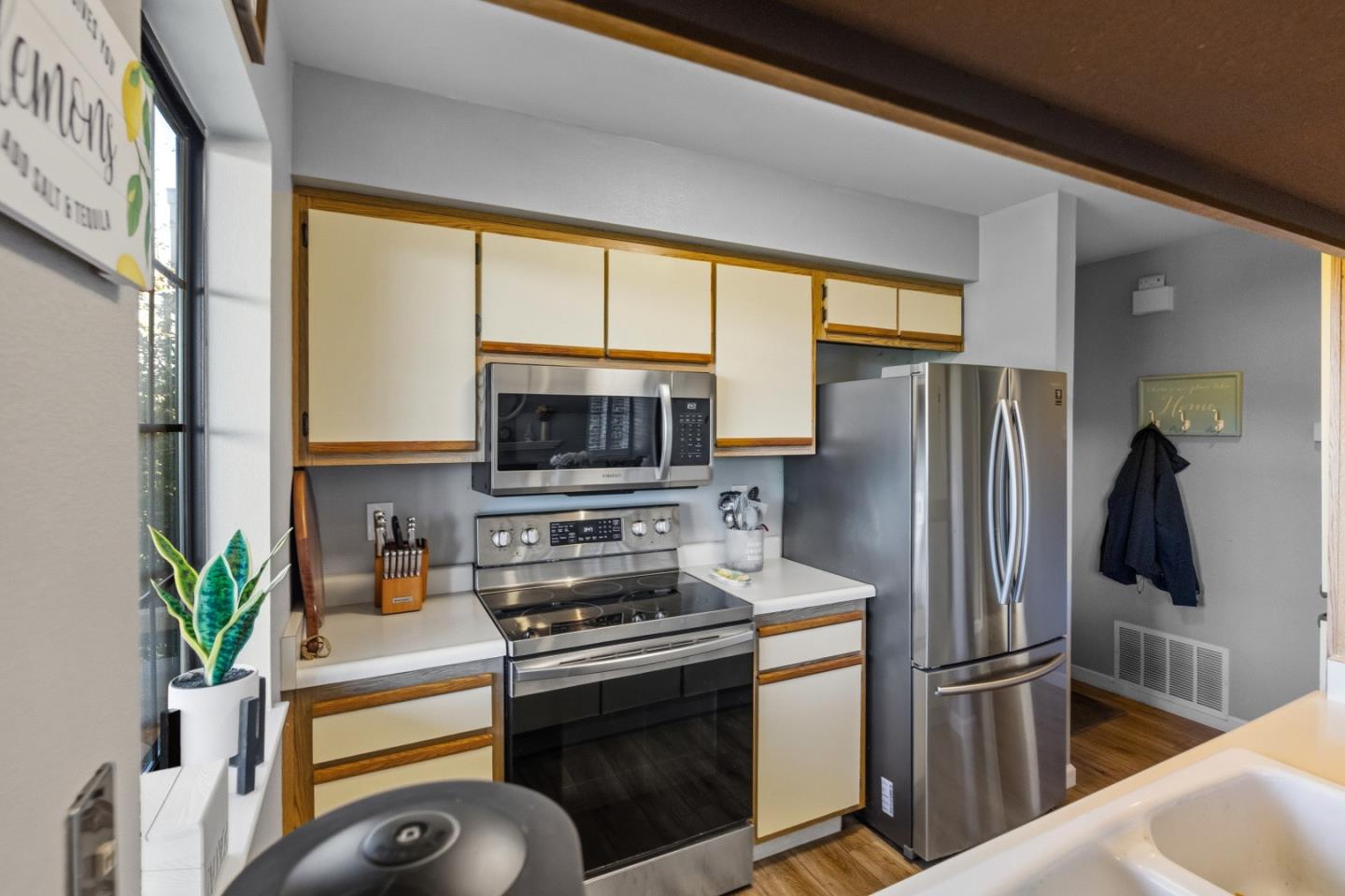 521 Quail Run Court Del Rey Oaks, CA 93940 - Photo 14 of 31 a kitchen with stainless steel appliances a refrigerator sink and stove