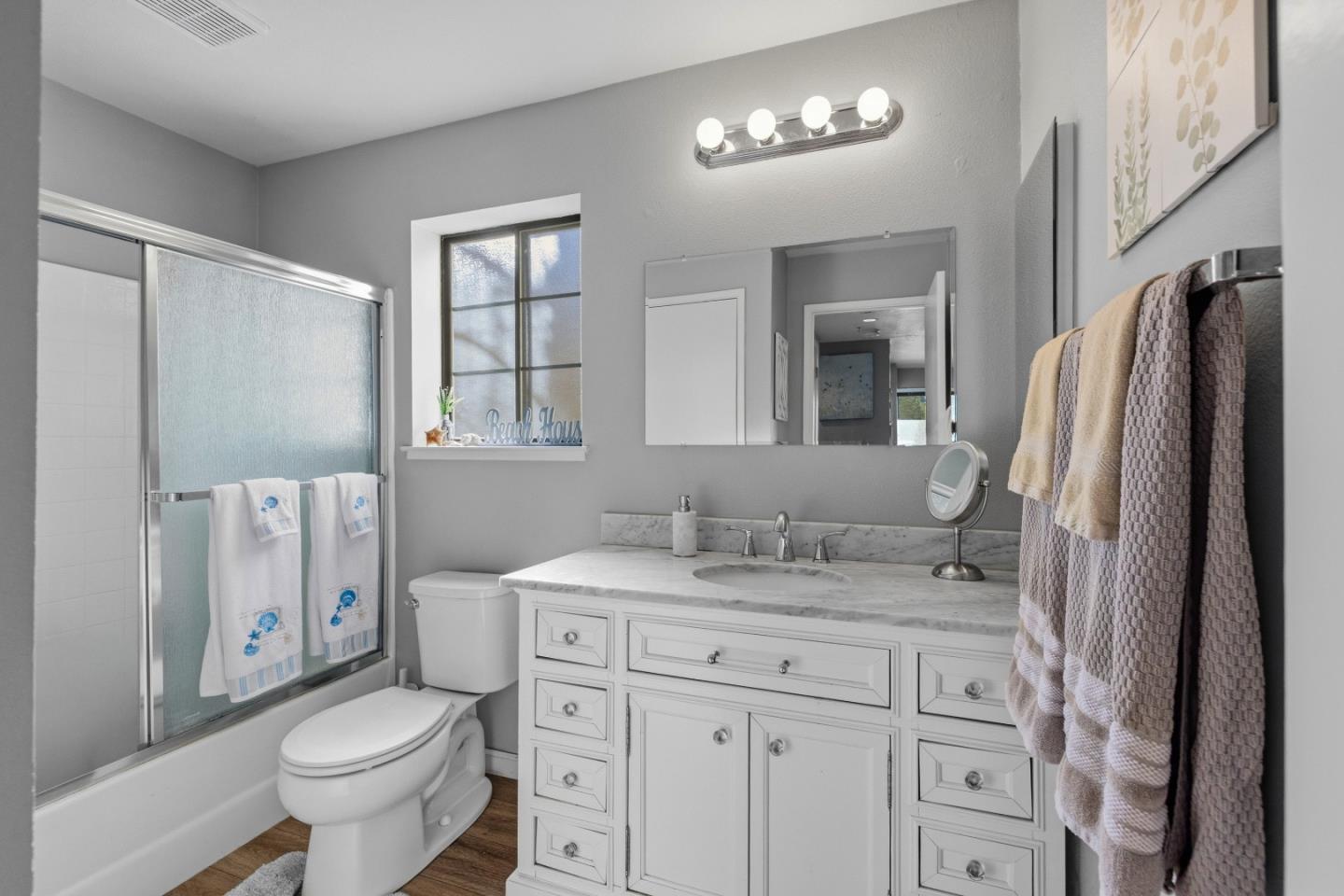 521 Quail Run Court Del Rey Oaks, CA 93940 - Photo 20 of 31 a bathroom with a granite countertop sink toilet a mirror a vanity and shower