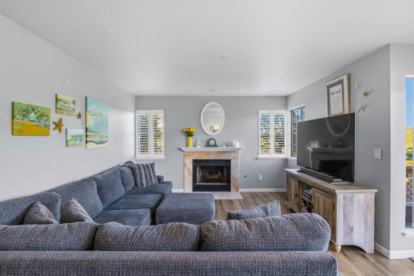 521 Quail Run Court Del Rey Oaks, CA 93940 - Photo 7 of 31 a living room with furniture a fireplace and a flat screen tv