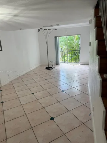 a view of a livingroom with a floor to ceiling window and a fireplace