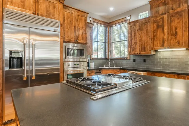 a kitchen with a table chairs and a window