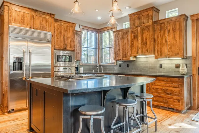 a kitchen with stainless steel appliances granite countertop a sink and a counter space
