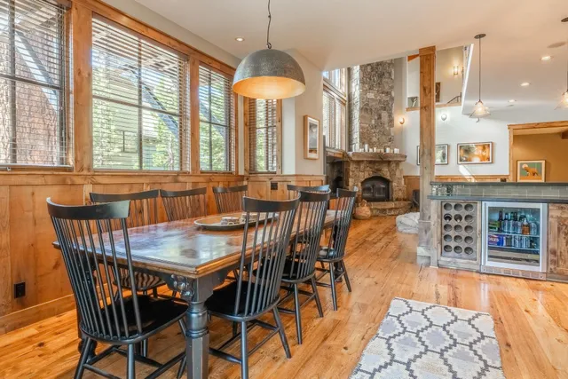 a dining room with furniture a chandelier and fireplace